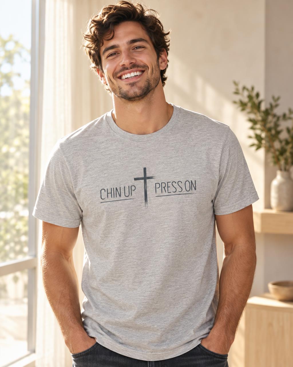 Young man wearing an Athletic Heather CHIN UP ✝ PRESS ON T-shirt in natural daylight.
